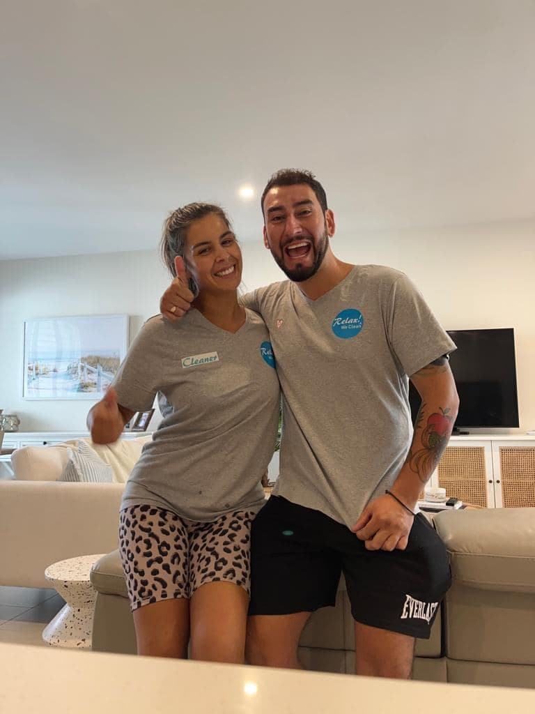 Two cleaning contractors from the Relax! We Clean network giving a thumbs up after completing a turnover