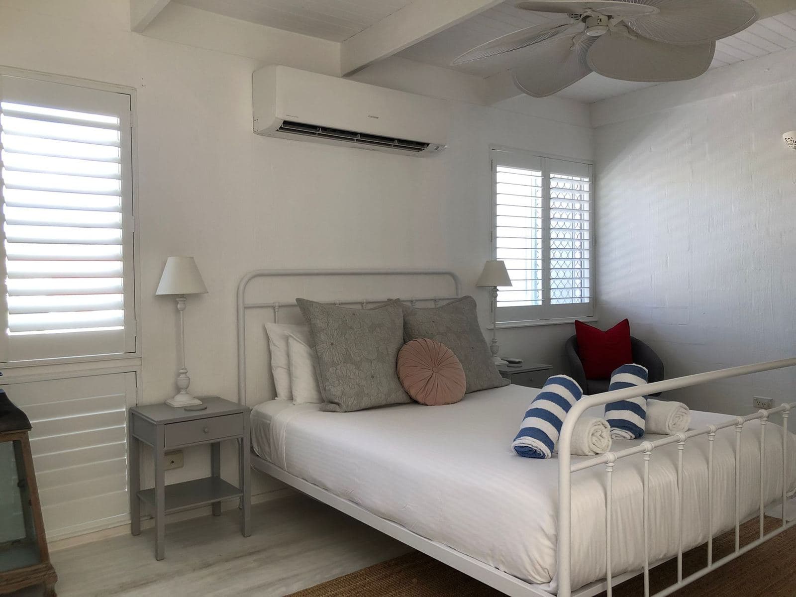 A freshly cleaned bedroom with neatly presented bedding and towels