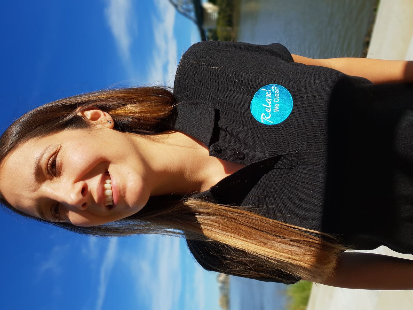A cleaning contractor from the Relax! We Clean network, photographed by the Brisbane River
